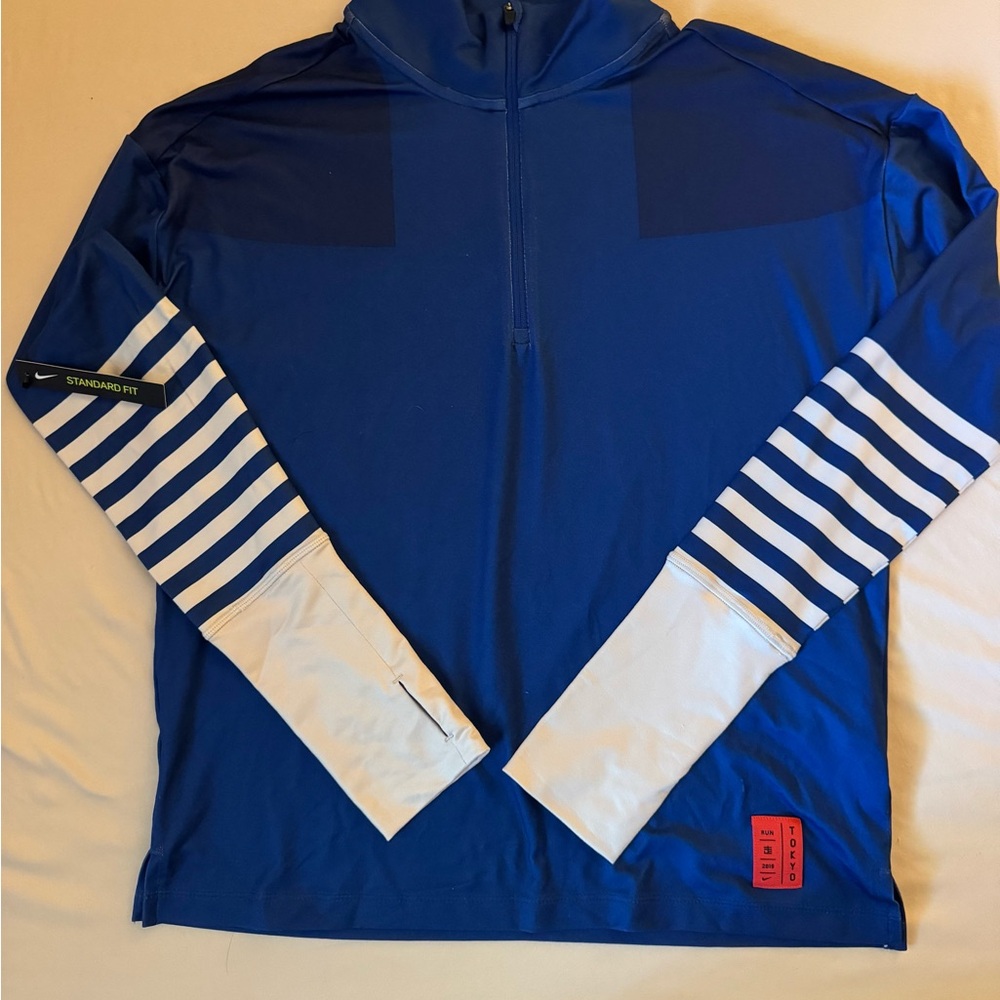TOKYO Nike Dri-Fit shirt. Back of shirt says TOKYO (see photo).